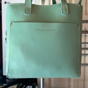 Brand new! Portland Leather mini zip Crossbody tote. Color is mint. Hard to find